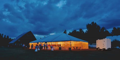 Outdoor night wedding with toilet trailer