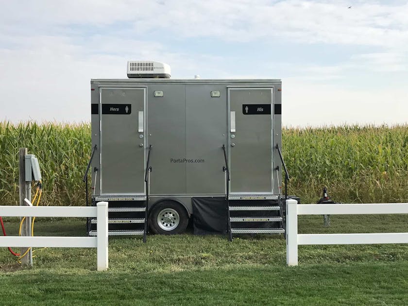 PortaPros toilet trailer at farm wedding.