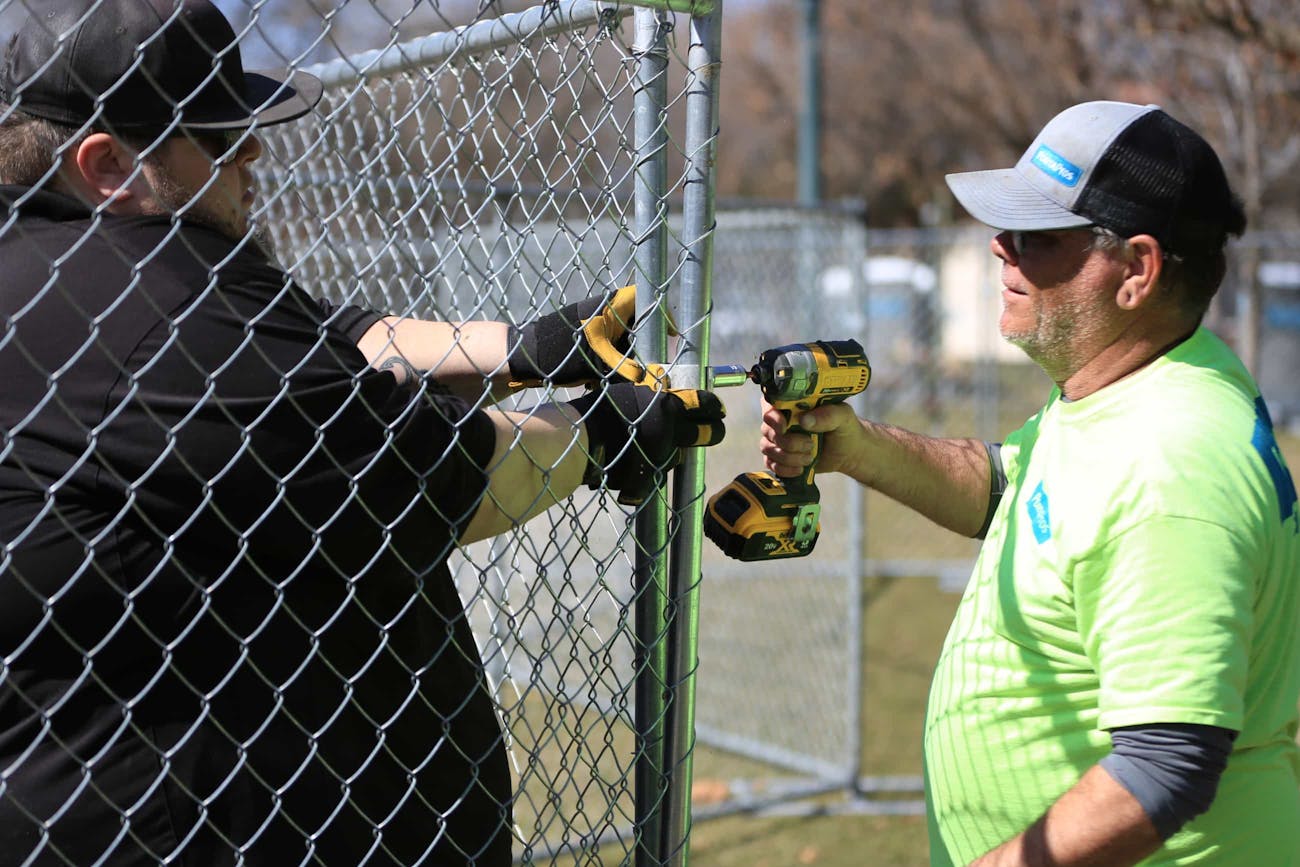 PortaPros team working on temporary fencing.