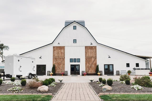 Beautiful wedding venue with PortaPros wedding restroom trailer outside.