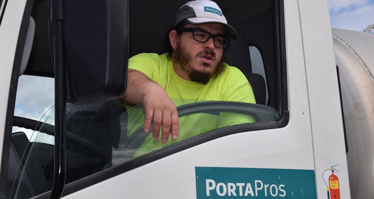 PortaPros employee leaning out truck window